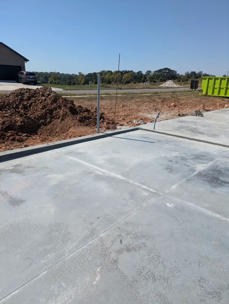 Concrete foundation edge beside excavated soil and utility lines Concrete foundation edge beside excavated soil and utility lines