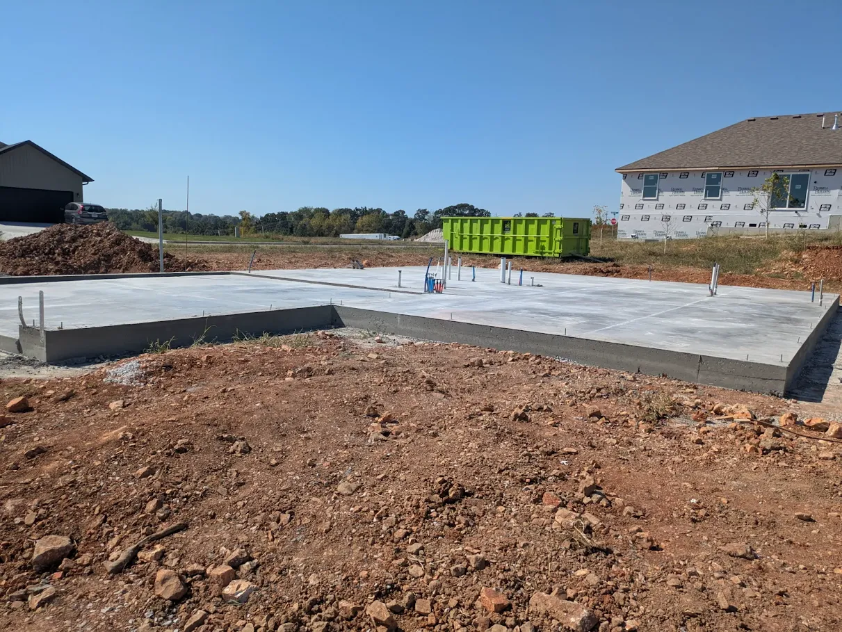 Completed concrete house slab with utility stub-outs on a residential construction site Completed concrete house slab with utility stub-outs on a residential construction site